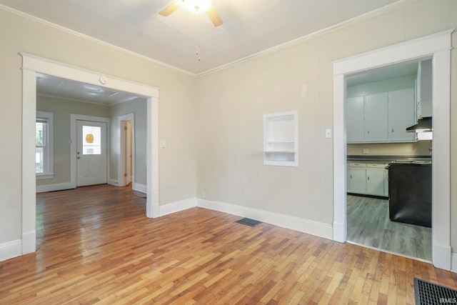 spare room featuring ornamental molding, ceiling fan, and light hardwood / wood-style floors