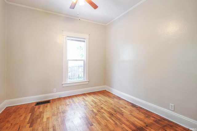 unfurnished room featuring ceiling fan, ornamental molding, and light wood-type flooring