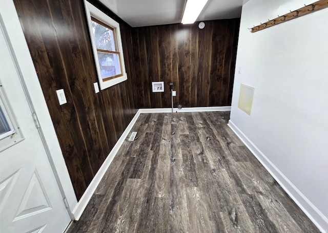 clothes washing area with dark hardwood / wood-style flooring, hookup for a washing machine, and wood walls