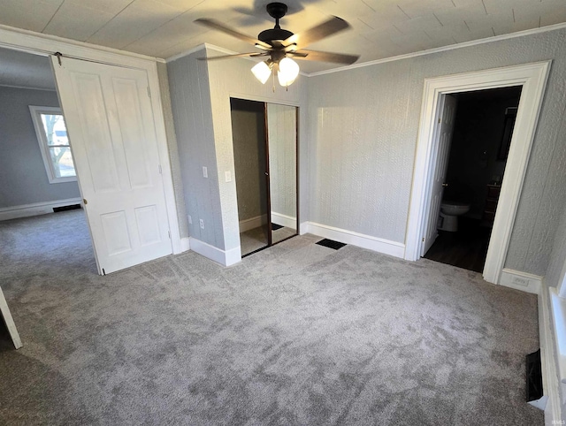 unfurnished bedroom featuring ornamental molding, carpet floors, connected bathroom, and ceiling fan