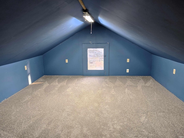 additional living space with vaulted ceiling and carpet