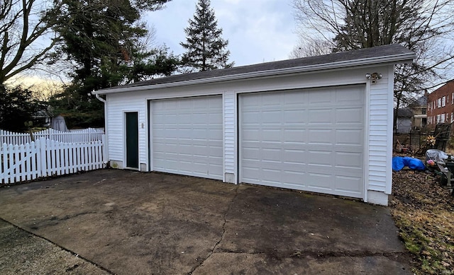 view of garage at dusk