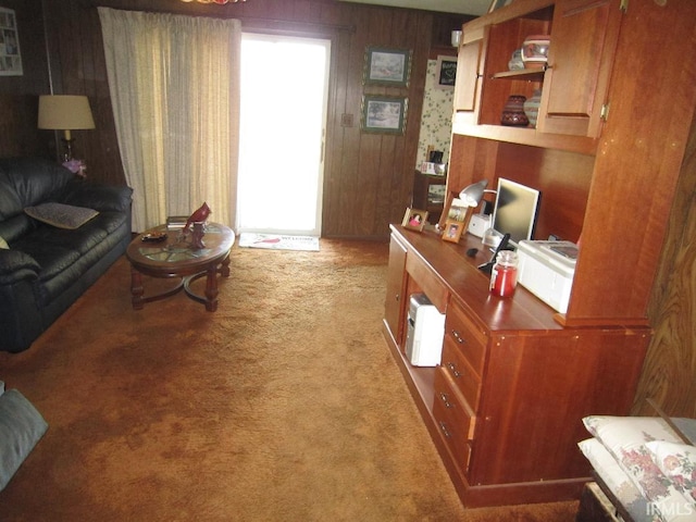 living area featuring light colored carpet and wood walls