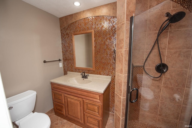 bathroom featuring vanity, an enclosed shower, tile patterned floors, and toilet