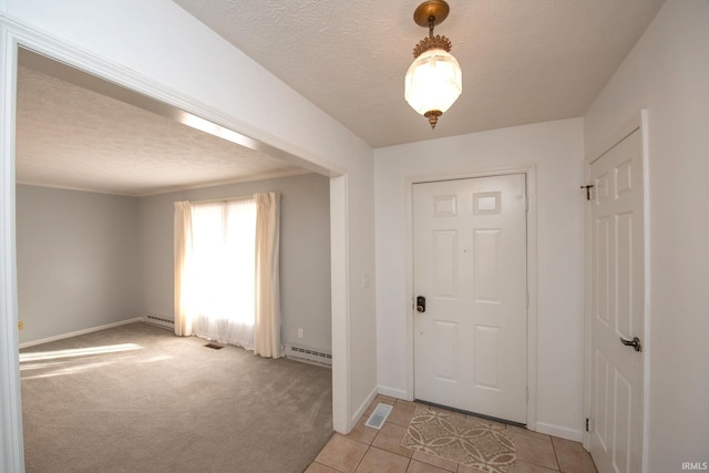 foyer entrance featuring a baseboard radiator, light carpet, and a textured ceiling