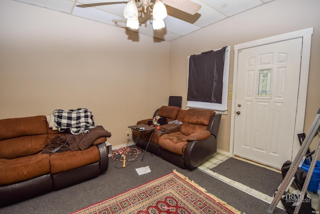 living room featuring ceiling fan, a paneled ceiling, and carpet