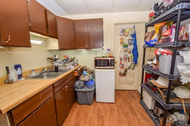 kitchen with sink and light hardwood / wood-style flooring