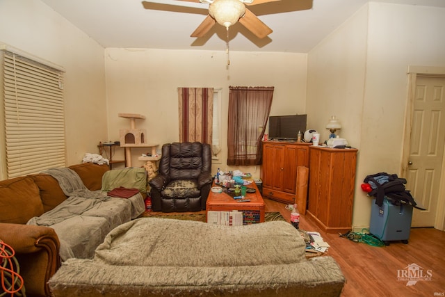 living room with light hardwood / wood-style flooring and ceiling fan