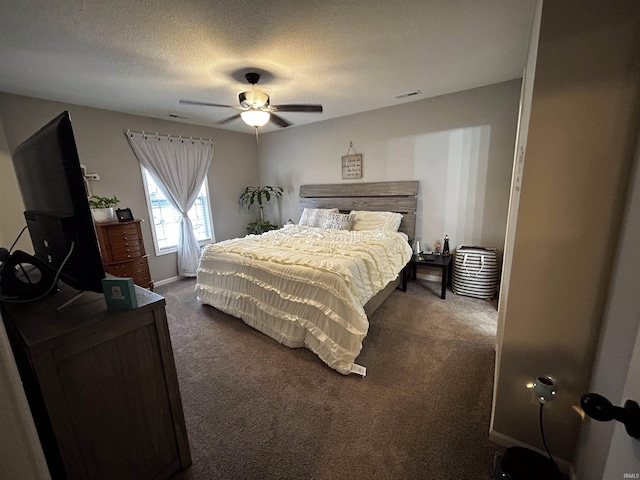 carpeted bedroom with ceiling fan and a textured ceiling