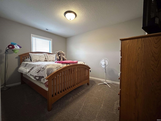 carpeted bedroom featuring a textured ceiling