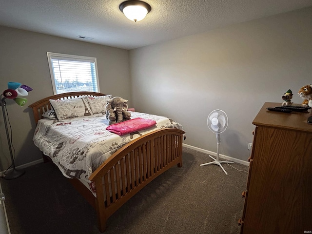 carpeted bedroom featuring a textured ceiling