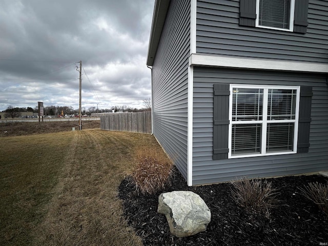 view of side of property with a lawn