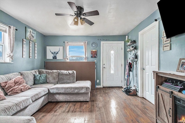 living room featuring wood-type flooring and ceiling fan