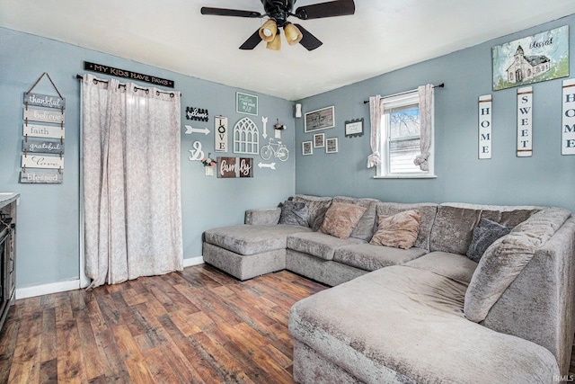 living room featuring ceiling fan and dark hardwood / wood-style flooring