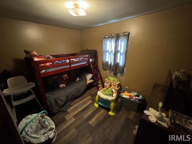 bedroom with hardwood / wood-style floors