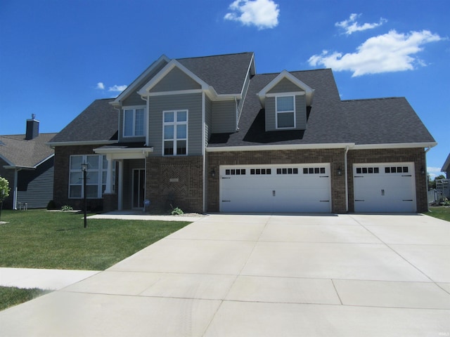 view of front of property with a garage and a front lawn