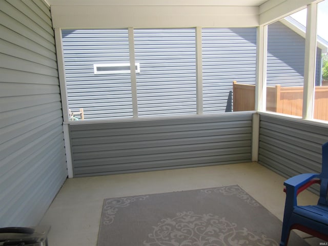 unfurnished sunroom featuring a jacuzzi