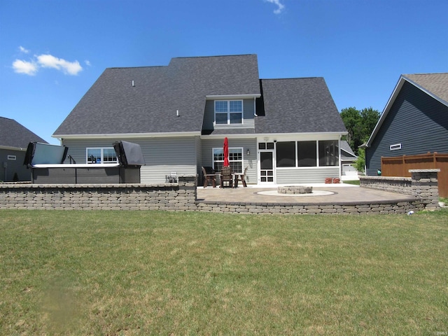 rear view of property featuring an outdoor fire pit, a yard, and a patio area