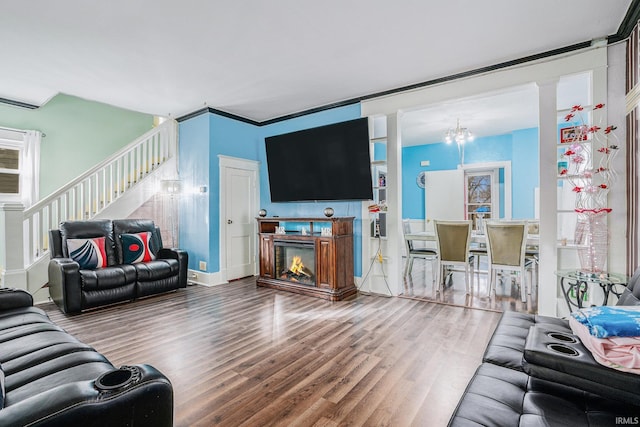 living room with an inviting chandelier and hardwood / wood-style flooring