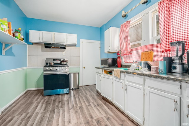 kitchen featuring backsplash, white cabinets, and appliances with stainless steel finishes