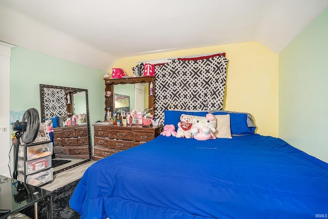 bedroom with vaulted ceiling and wood-type flooring