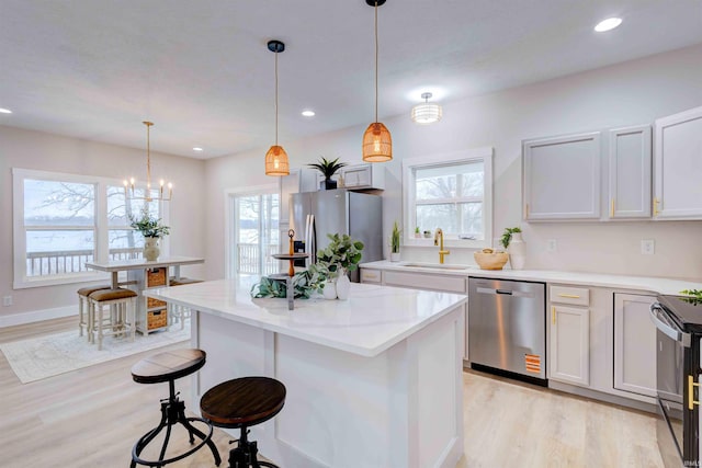1192 Greer Ln, Springville, IN 47462 - kitchen with stainless steel appliances, hanging light fixtures, sink, and white cabinets