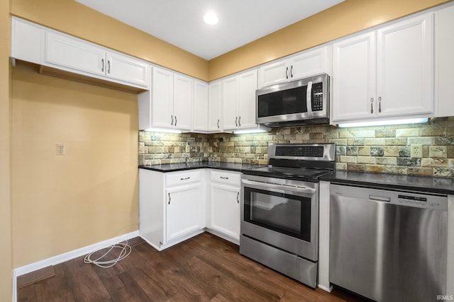 kitchen featuring white cabinetry, backsplash, stainless steel appliances, and dark hardwood / wood-style floors