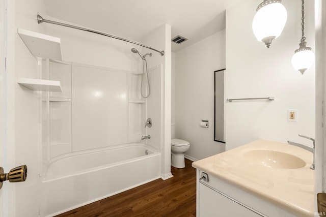 full bathroom featuring vanity, tub / shower combination, hardwood / wood-style floors, and toilet