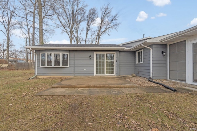 rear view of property featuring a yard and a patio