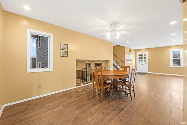 dining area with ceiling fan and wood-type flooring