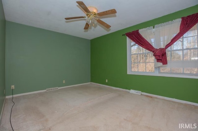 carpeted spare room with ceiling fan