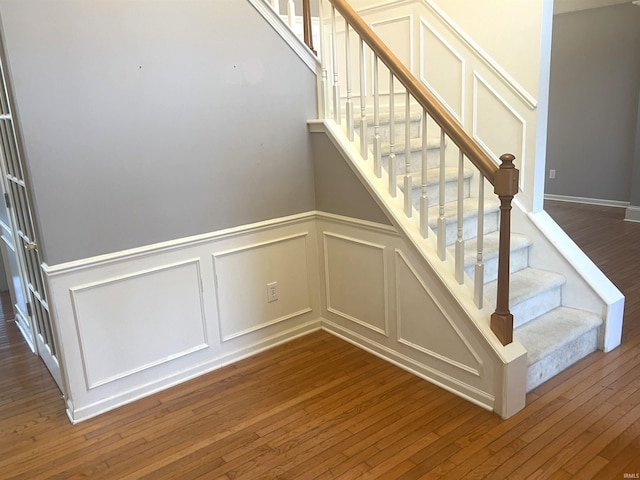 staircase with hardwood / wood-style floors