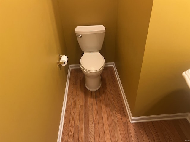 bathroom with hardwood / wood-style floors and toilet