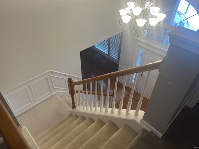 stairway featuring an inviting chandelier