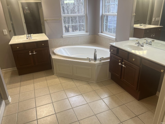 bathroom featuring tile patterned floors, a bathtub, and vanity