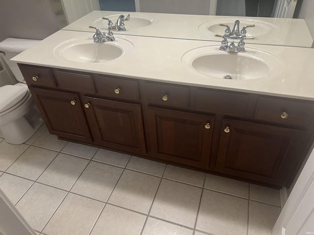 bathroom featuring vanity, tile patterned flooring, and toilet