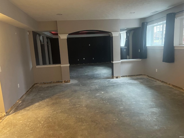 unfurnished room featuring ornate columns