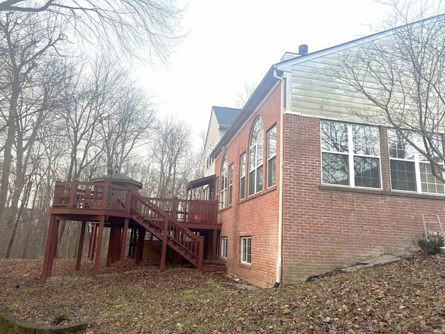 view of property exterior with a deck