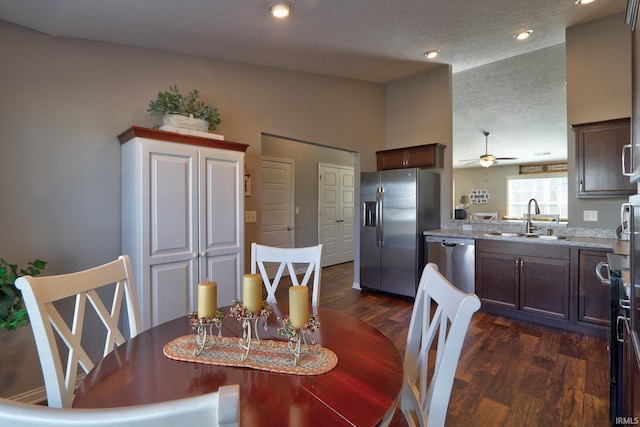 dining space with lofted ceiling, sink, a textured ceiling, dark hardwood / wood-style flooring, and ceiling fan