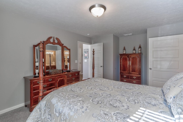 carpeted bedroom featuring a textured ceiling