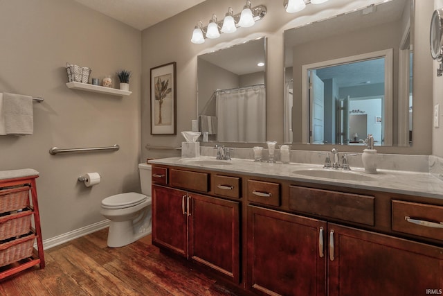 bathroom featuring vanity, hardwood / wood-style floors, and toilet