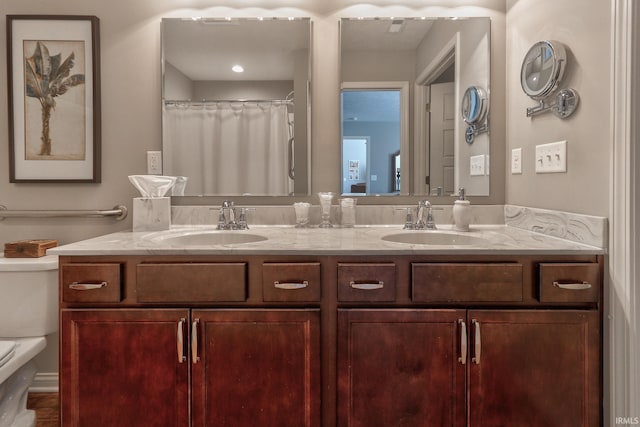 bathroom with vanity, toilet, and curtained shower