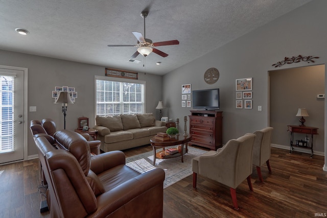 living room with vaulted ceiling, dark hardwood / wood-style floors, a textured ceiling, and ceiling fan