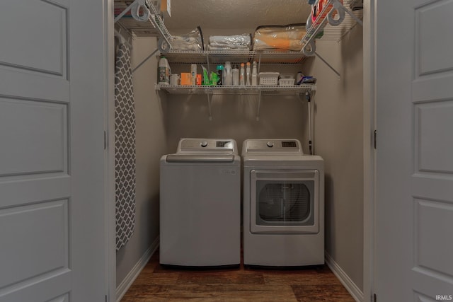 laundry room with dark hardwood / wood-style floors and washer and dryer