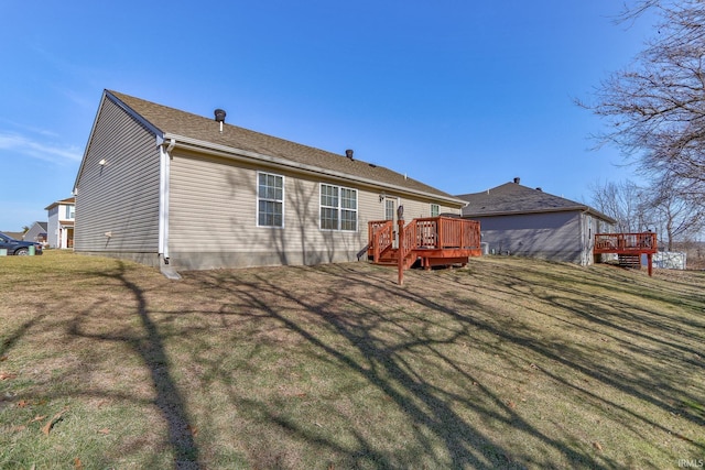 back of property featuring a wooden deck and a yard