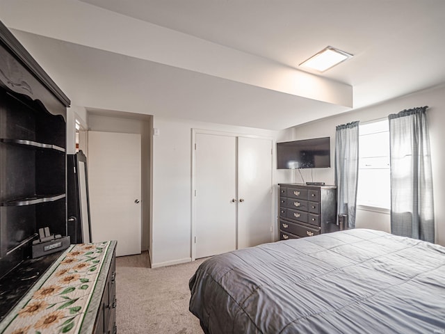 carpeted bedroom featuring a closet