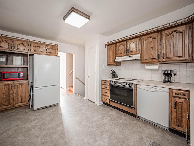 kitchen with tasteful backsplash and white appliances