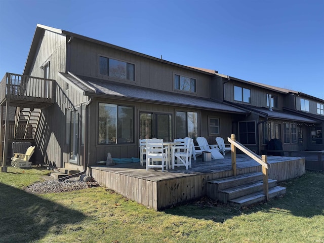 rear view of house with a yard and a deck