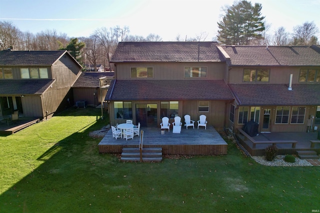 rear view of property with a wooden deck, a yard, and central AC