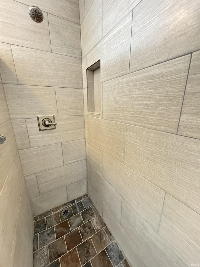 bathroom with a tile shower